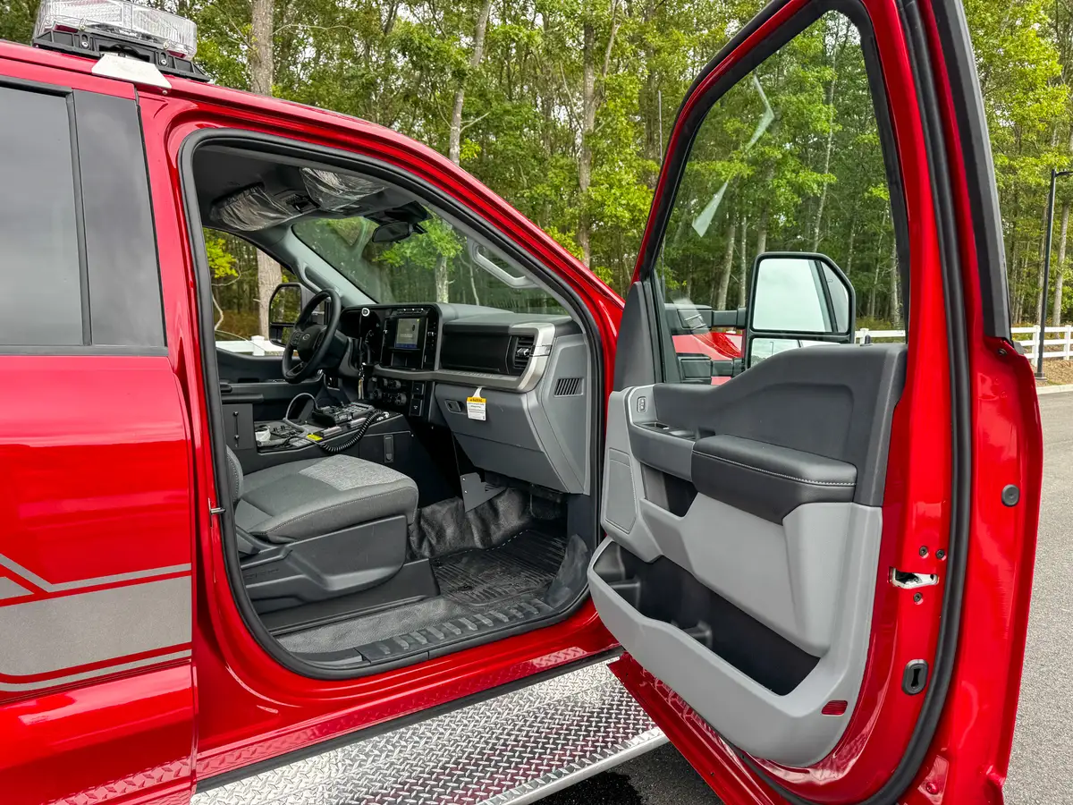 Overhead front-cabin view showing visor area and roof-mounted control panel.